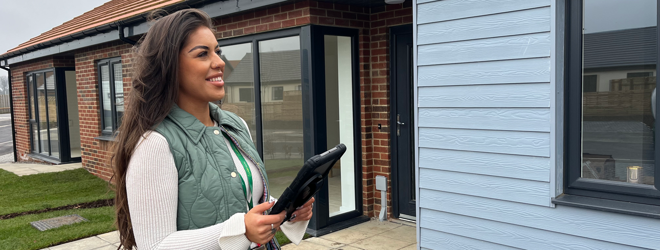 Repairs and empty homes inspector, Antonia Thompson outside a new build bungalow